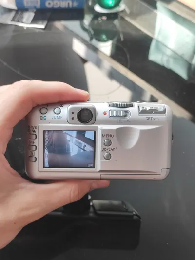 Multi-item sale: PSP GO, manga box set, two cameras — 9/10